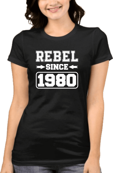 Lady wearing Black graphic Tee with "Rebel since 1980" design from the Xpert Apparel Store