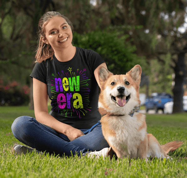 Beautiful girl sitting in the park with her dog wearing a t-shirt  with New Era printed on the front, available from the Xpert Apparel Store