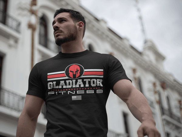 Guy walking outdoor wearing Black T-shirt with Gladiator Fitness Logo design red and white on the front Available from the Xpert Apparel Store.