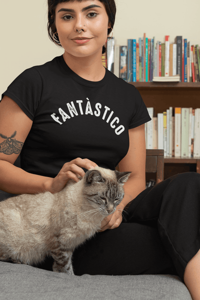 Lady sitting on couch with cat wearing black t-shirt with Fantastico design, available from the Xpert Apparel Store 
