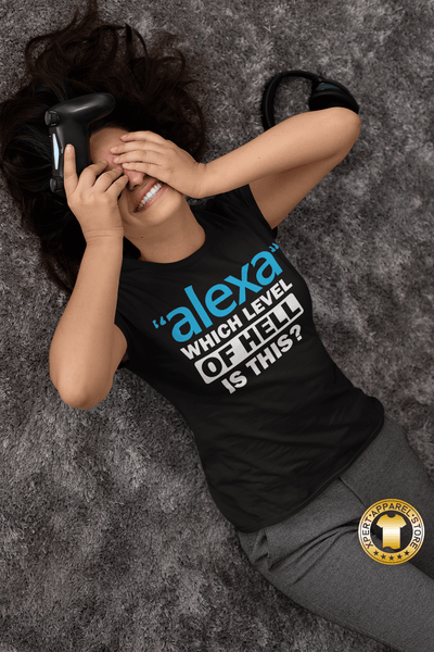 Gamer Girl laying on her back with hands over her eyes laughing wearing a black t-shirt with "Alexa" which level of hell is this t-shirt design, available from the Xpert Apparel Store.