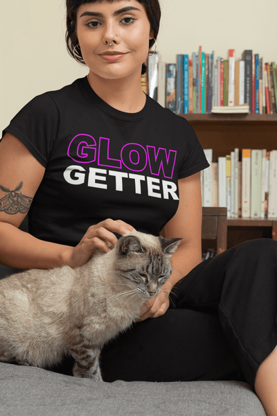 Female sitting on couch with her cat wearing a black T-shirt with Glow Gwtter Design on front available from the Xpert Apparel Store 