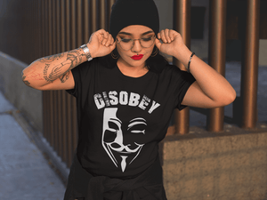 Female wearing  Black T-shirt with  Vendetta mask Disobey T-shirt design available from the  Xpert Apparel Store 